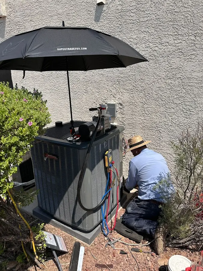 HVAC technician performing outdoor AC maintenance in Monett